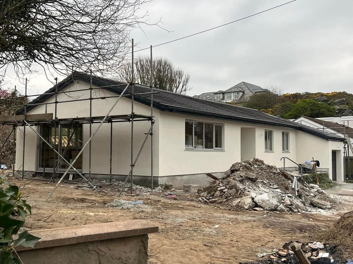 Bungalow being rendered with scaffolding in place