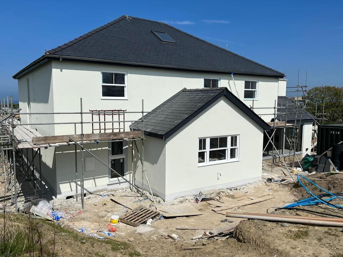 Two-storey house and extension being rendered, with scaffolding up